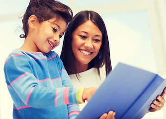 Image showing mother and daughter with book