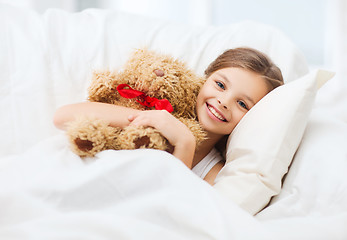 Image showing little girl with teddy bear sleeping at home