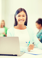 Image showing asian businesswoman with laptop and documents