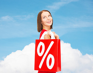 Image showing woman in red dress with shopping bags