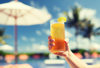 Image showing close-up of hand holding glass with cocktail