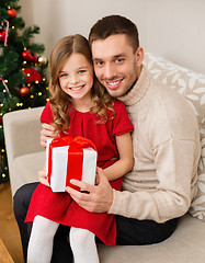 Image showing smiling father and daughter holding gift box