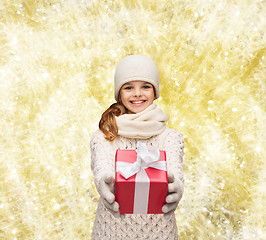 Image showing dreaming girl in winter clothes with gift box