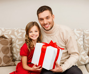 Image showing smiling father and daughter holding gift box