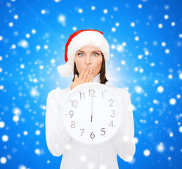 Image showing woman in santa helper hat with clock showing 12