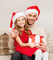 Image showing smiling father and daughter holding gift box