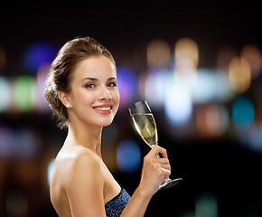 Image showing smiling woman holding glass of sparkling wine