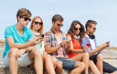 Image showing group of friends with smartphones outdoors