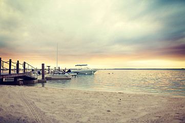 Image showing boats moored to pier at sundown