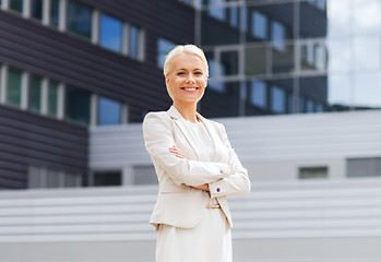 Image showing young smiling businesswoman with crossed arms