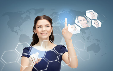 Image showing smiling businesswoman working with virtual screen