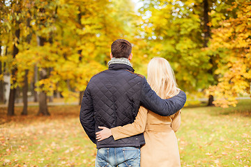 Image showing couple hugging in autumn park from back