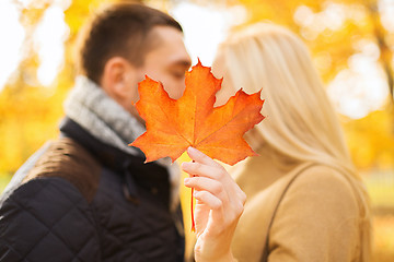 Image showing close up of couple kissing in autumn park