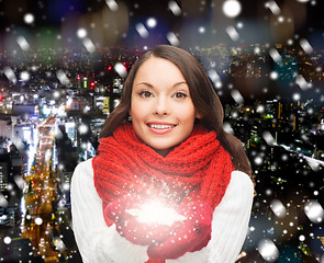 Image showing smiling woman in winter clothes with snowflake