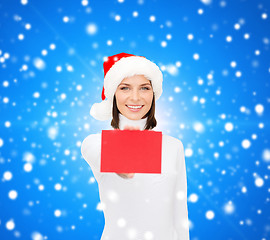 Image showing woman in santa helper hat with blank red card