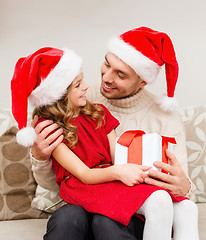 Image showing smiling father and daughter holding gift box