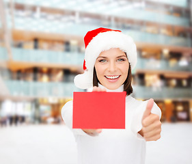 Image showing woman in santa helper hat with blank red card