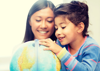 Image showing mother and daughter with globe