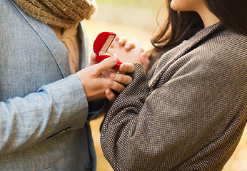 Image showing close up of couple with gift box in park