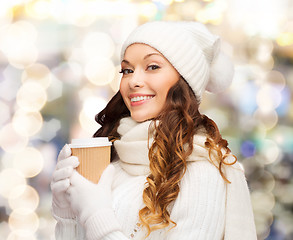 Image showing smiling young woman in winter clothes with cup