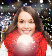 Image showing smiling woman in winter clothes with snowball