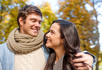 Image showing smiling couple hugging in autumn park