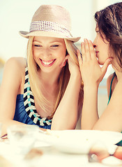 Image showing girls gossiping in cafe on the beach