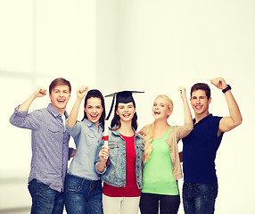 Image showing group of standing smiling students with diploma