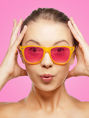 Image showing surprised teenage girl in pink sunglasses