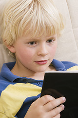 Image showing Little boy reading a book