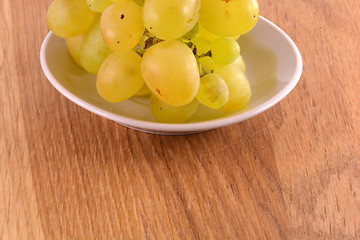 Image showing A close-up of grapes on white table