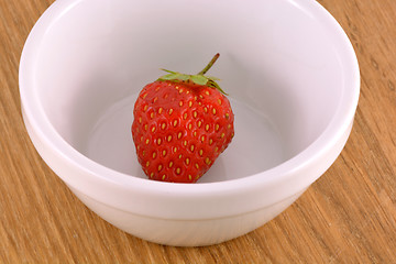 Image showing bowl with strawberries on wood background