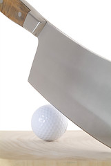 Image showing Meat-cleaver and golf-ball