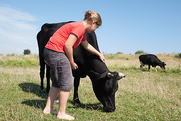 Image showing Young girl with cows