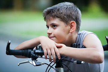 Image showing Portrait of little boy on a bicycle outdoors