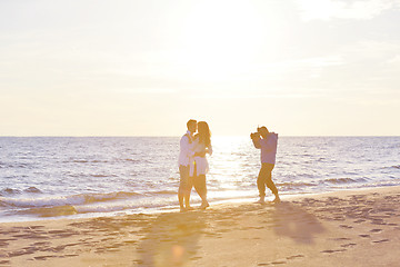 Image showing photographer taking photo on beach