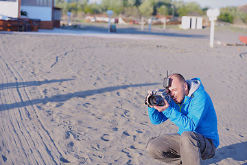 Image showing photographer taking photo on beach