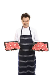 Image showing Butcher with trays of T-bone steak