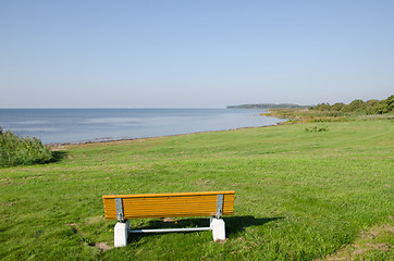 Image showing Wooden bench by a calm bay