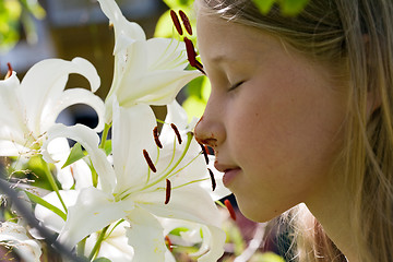 Image showing girl smelling flowers