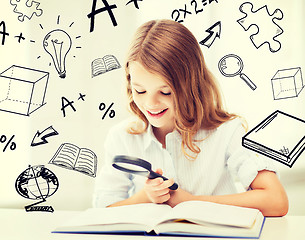 Image showing girl reading book with magnifier at school