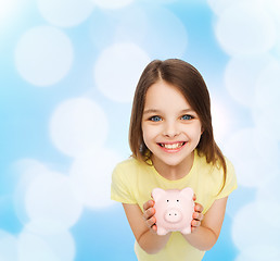 Image showing beautiful little girl with piggy bank