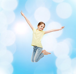 Image showing smiling little girl jumping