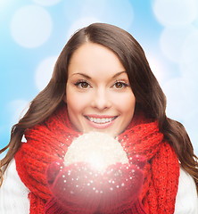 Image showing smiling woman in winter clothes with snowball