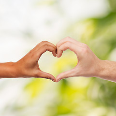 Image showing woman and man hands showing heart shape