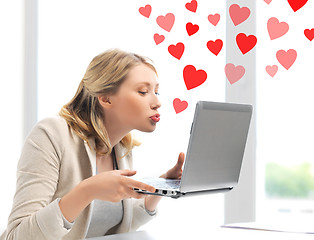 Image showing woman sending kisses with laptop computer