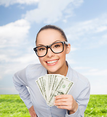 Image showing smiling businesswoman with dollar cash money