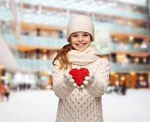 Image showing dreaming girl in winter clothes with red heart