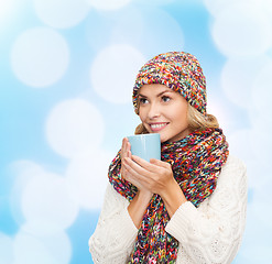 Image showing smiling young woman in winter clothes with cup