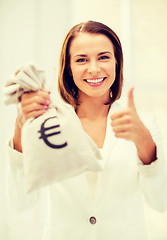 Image showing businesswoman holding money bag